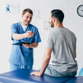 smiling-physiotherapist-with-diagnosis-and-pen.webp
